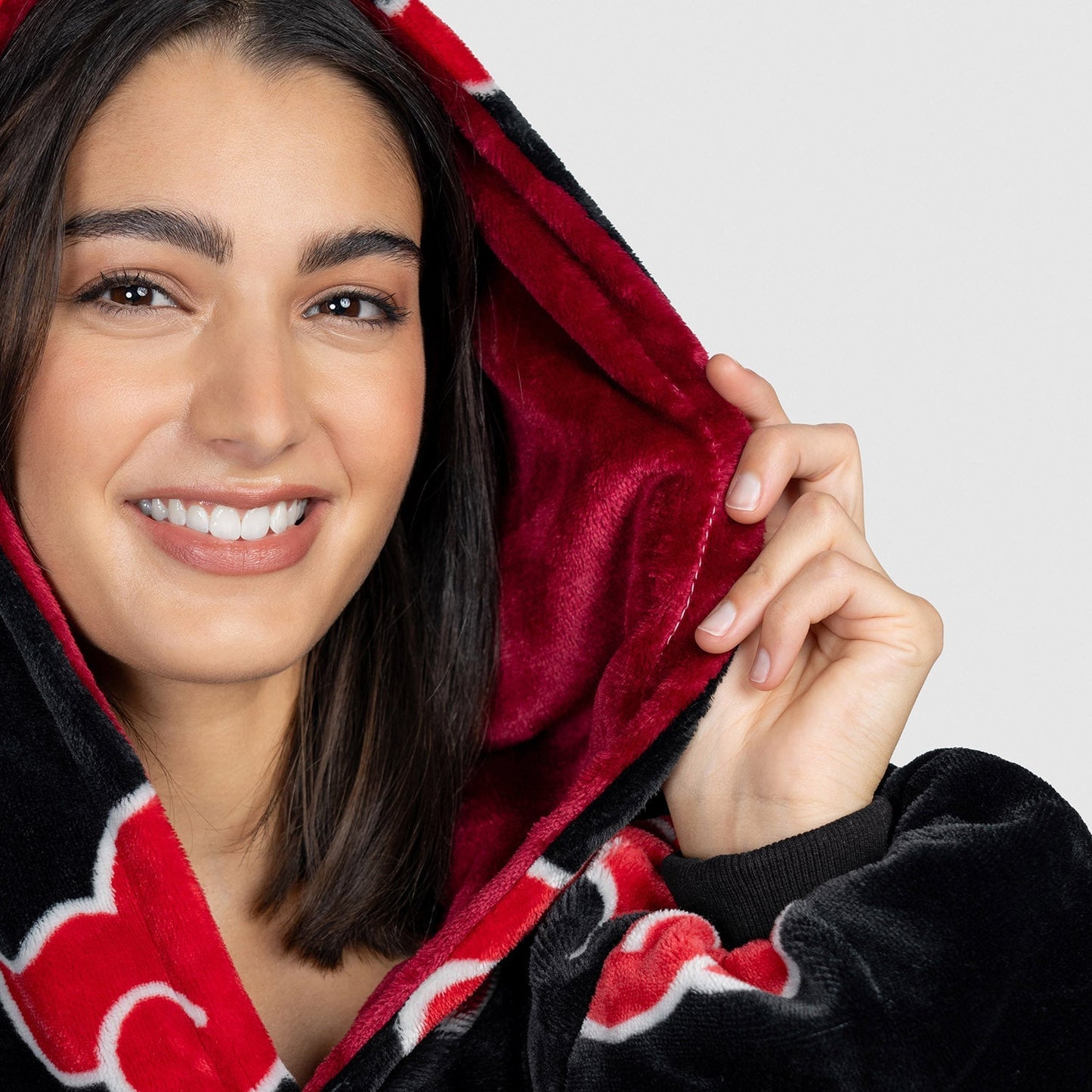 Close up of a woman's face in a Naruto oodie size: Adriana is 5'9" wearing a size OOD