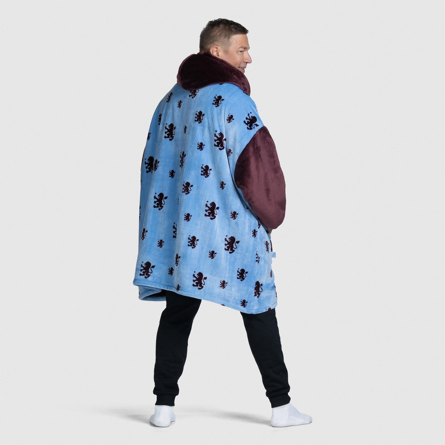 Man wearing a blue coat with maroon sleeves and collar, standing sideways; size: Steven is 6” wearing a size OOD