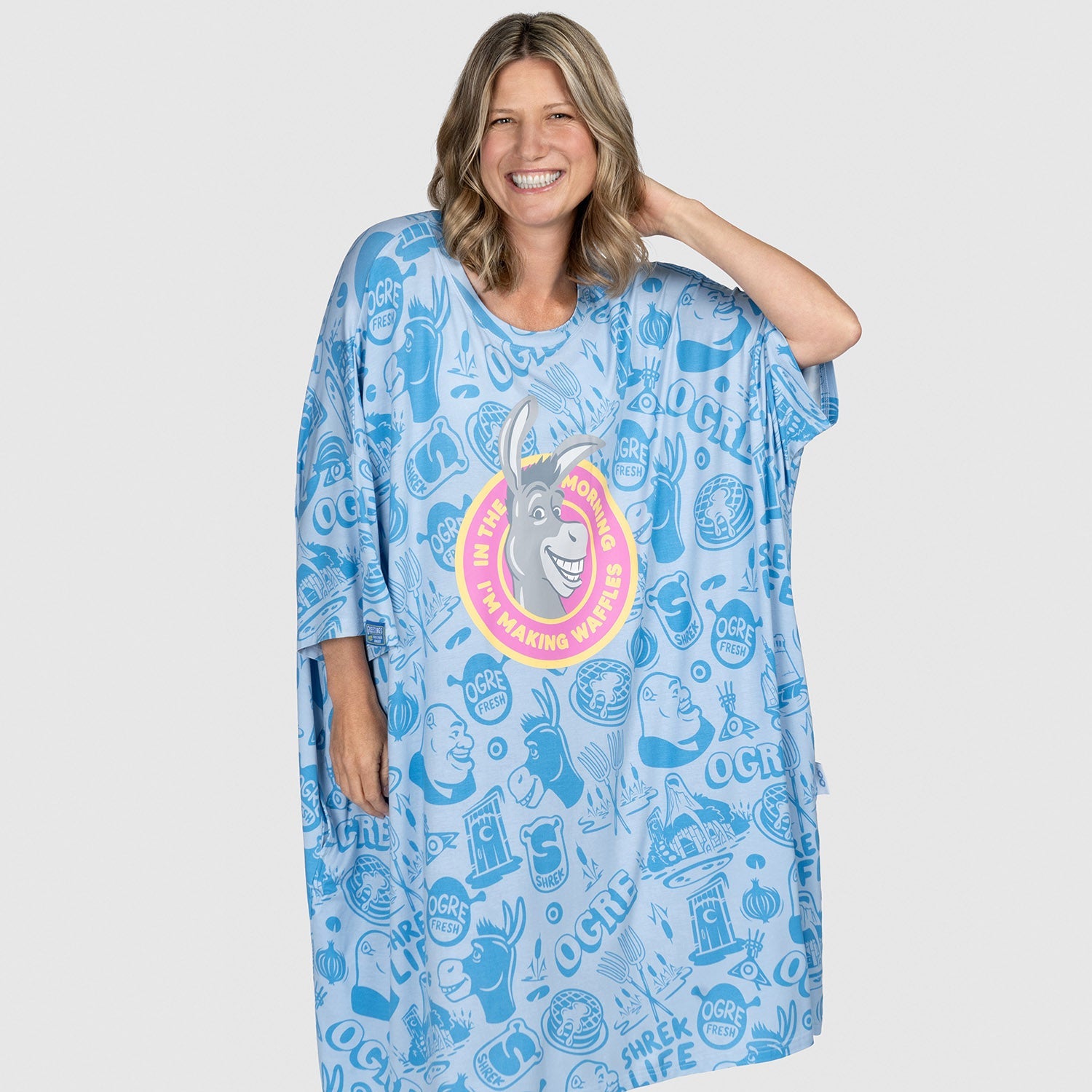 Woman wearing a blue oversized garment featuring Donkey from Shrek with the text 'I'm the Donkey who's making waffles' and multiple 'Ogre' logos and designs