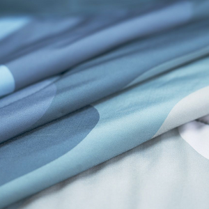 Close-up of folded blue fabric with abstract shapes