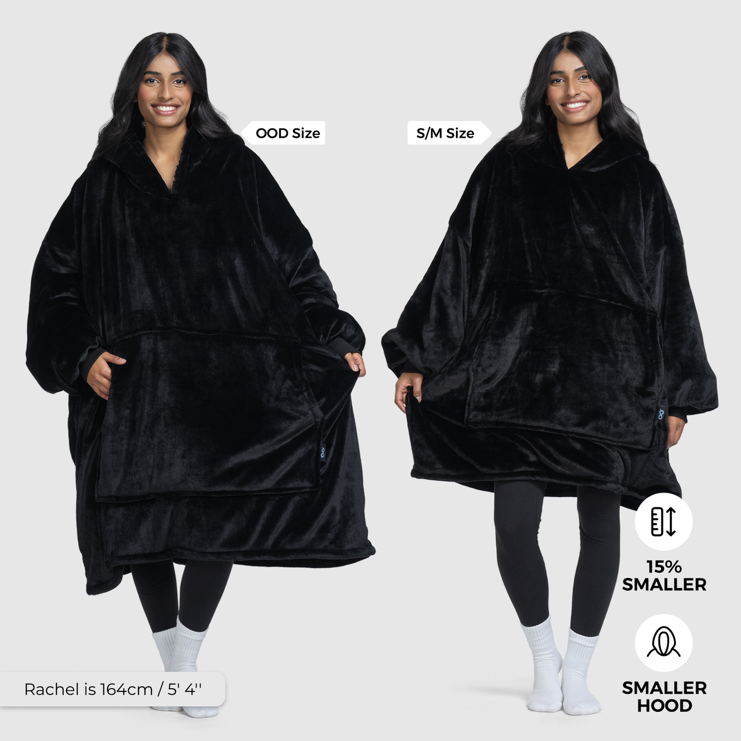 Woman wearing a black wearable blanket in two sizes labeled 'OOD Size' and 'S/M Size' with icons showing '15% SMALLER' and 'SMALLER HOOD'. Model is 164cm / 5'4