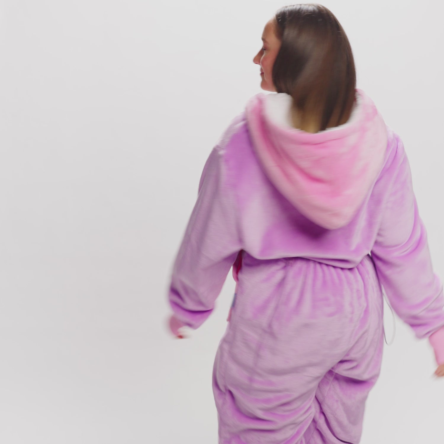 Person wearing a pink and purple hooded outfit seen from the back