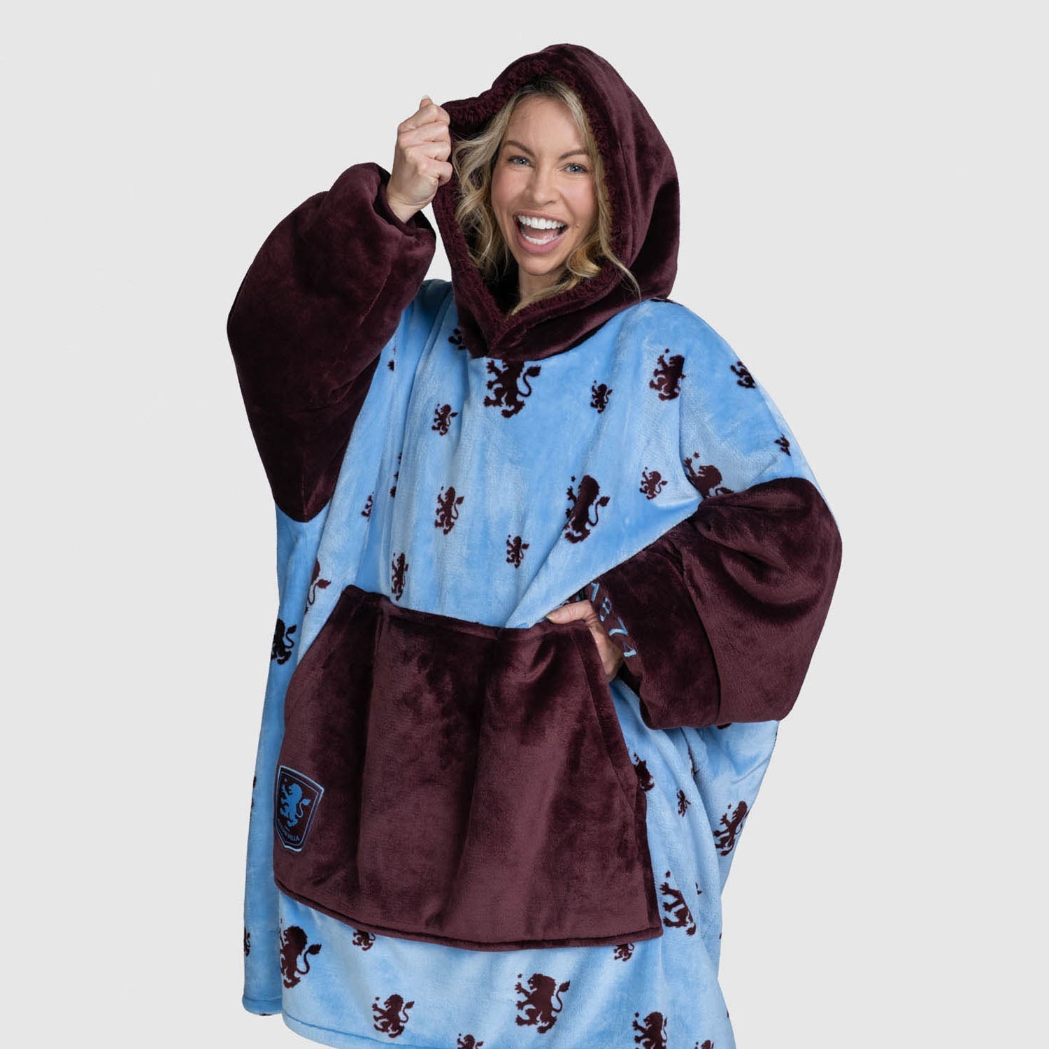 Woman smiling wearing a blue and maroon hooded wearable blanket with lion patterns, text: size: Emily is 5’3” wearing a size OOD