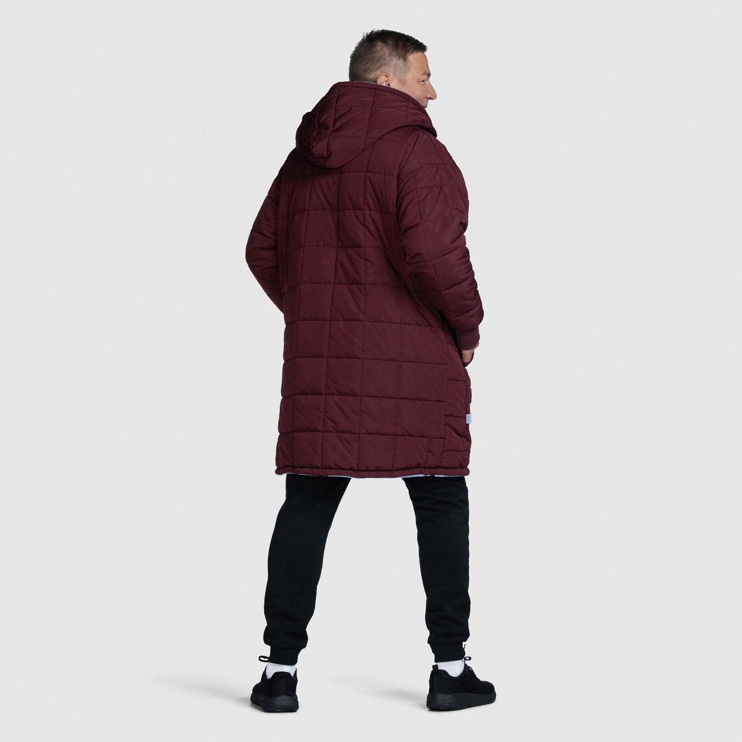 Man wearing a long maroon quilted coat with hood, standing facing away. size: Steven is 6” wearing a size OOD