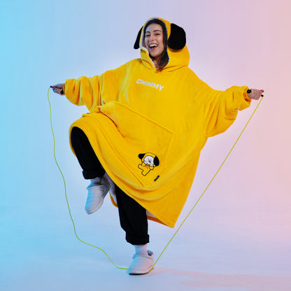 Person wearing a yellow BT21 Chimmy hoodie jumping rope with a joyful expression