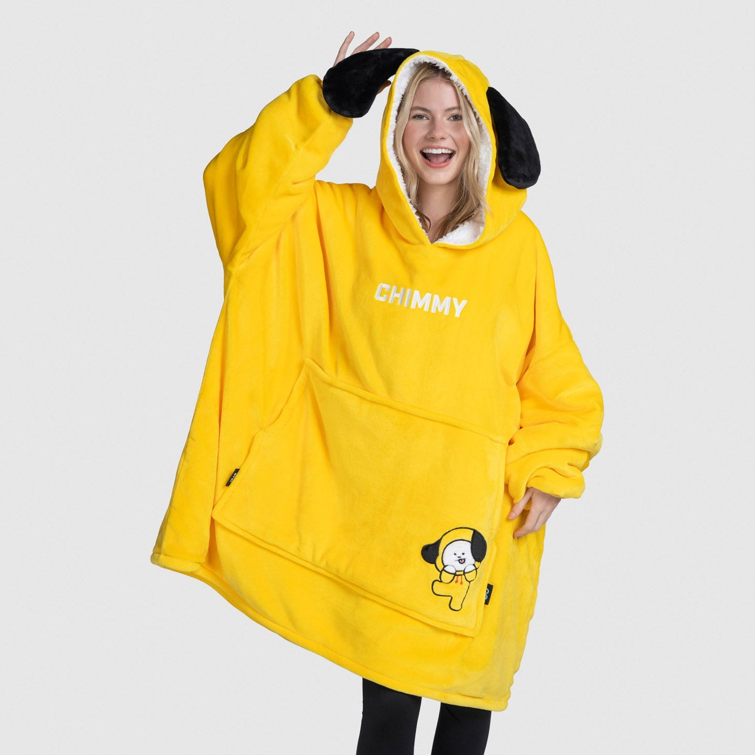 Woman wearing oversized yellow Chimmy hoodie with black ears and front pocket featuring Chimmy character