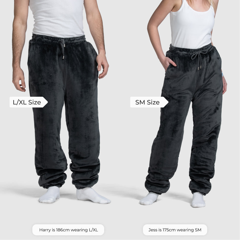 Two people modeling black plush pants labeled L/XL size and SM size; text includes 'L/XL Size', 'SM Size', 'Harry is 186cm wearing L/XL', 'Jess is 175cm wearing SM'.