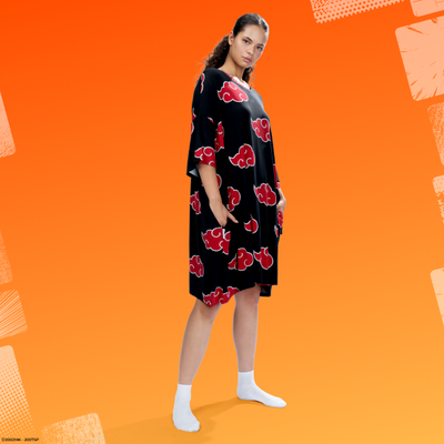 Woman wearing a black dress with red Akatsuki cloud patterns standing against an orange background