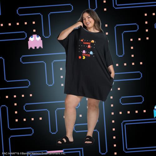Person wearing a black dress with Pac-Man characters and the words 'GAME OVER' on the front.