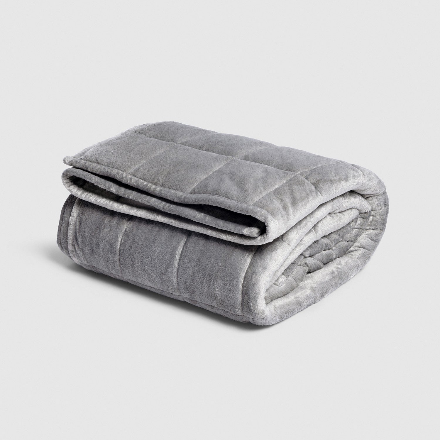 Folded gray weighted blanket with quilted stitching on a light background