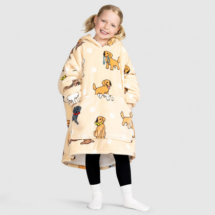 Child wearing an oversized beige hoodie with cartoon retriever dogs printed on it